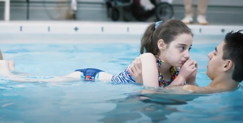 Crimson Adaptive Swim Program instructor and participant during a swim session.